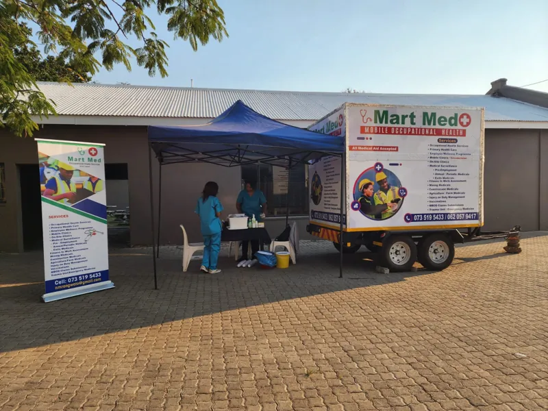 The mobile clinic trailer and gazebo set up outside a workplace