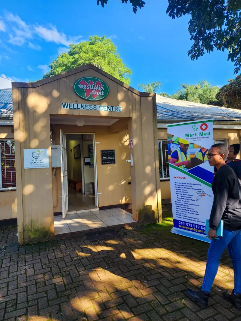 The front entrance of a Mart Med clinic with a pull-up banner