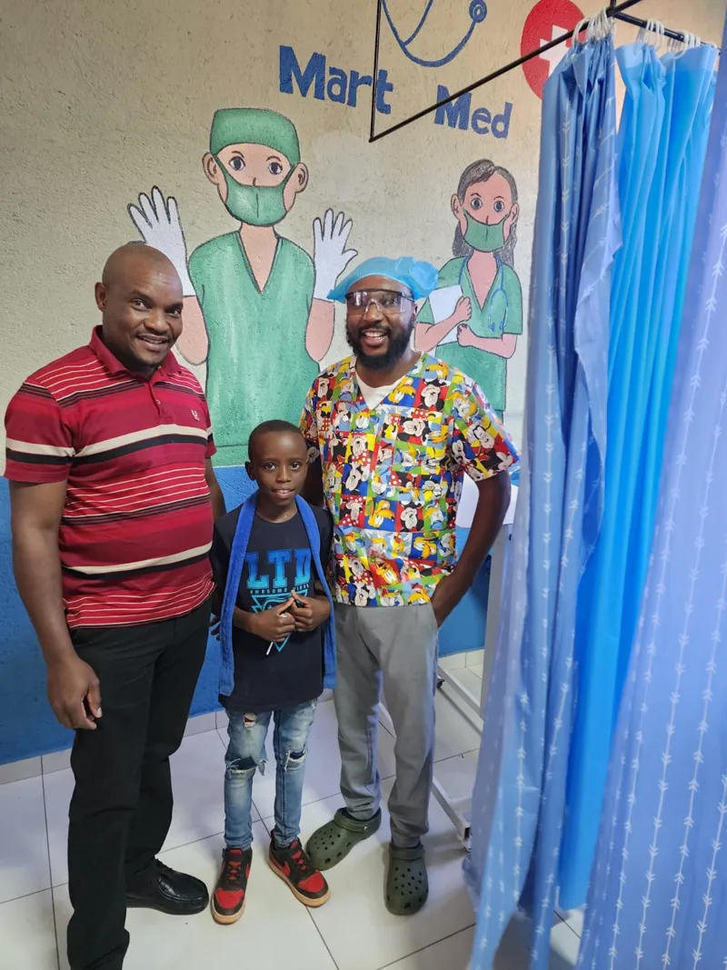 Staff with a young patient at the clinic