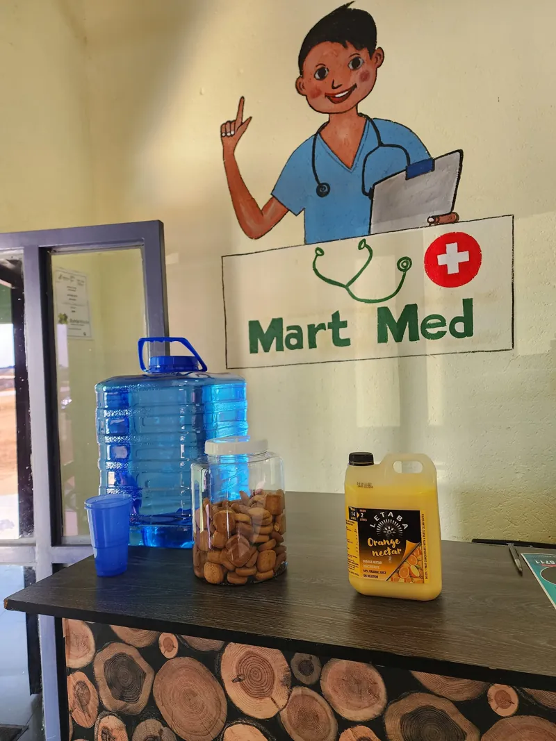 The Mart Med reception desk with the clinic mascot painted on the wall